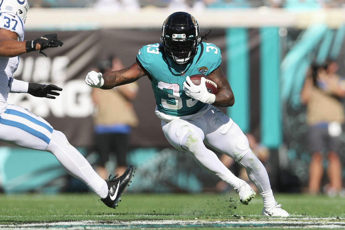 JACKSONVILLE, FL - JANUARY 09: Jacksonville Jaguars running back Dare Ogunbowale (33) tries to make a cut past Indianapolis Colts safety Khari Willis (37) as he rushes with the ball during the game between the Indianapolis Colts and the Jacksonville Jaguars on January 9, 2022 at TIAA Bank Field in Jacksonville, FL (Photo by Icon Sportswire)