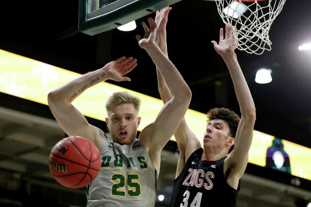 San Francisco forward Yauhen Massalski (25) is defended by Gonzaga center Chet Holmgren (34) during the first half of an NCAA college basketball game in San Francisco, Calif., Thursday, Feb. 24, 2022. (AP Photo/Jed Jacobsohn)