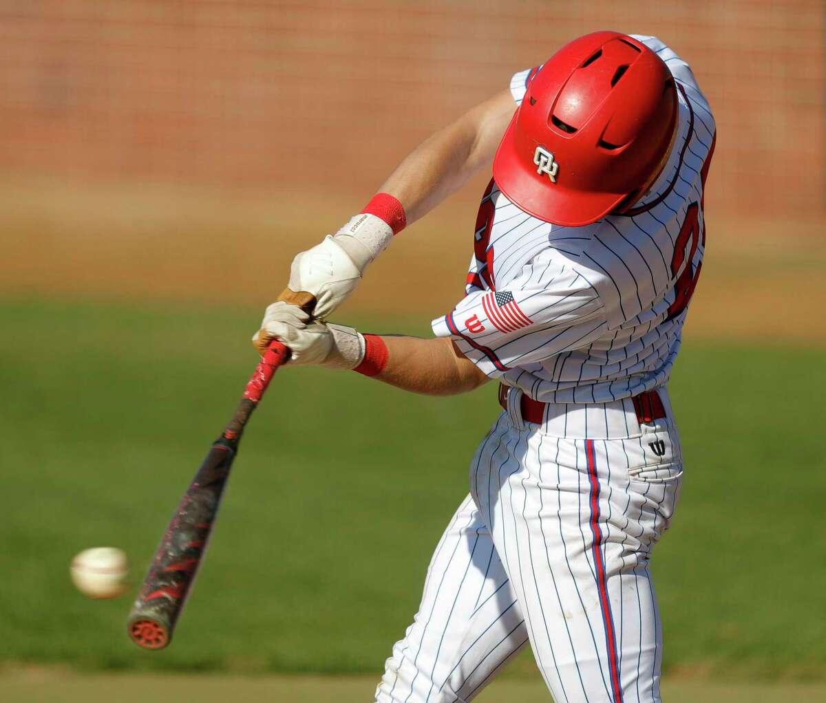 Seth Henry #26 of Oak Ridge connects on a pitch in the fourth inning of a high school baseball game at Oak Ridge High School, March 16, 2022. Henry reached first on an error by The Woodlands second baseman Parker McGill.