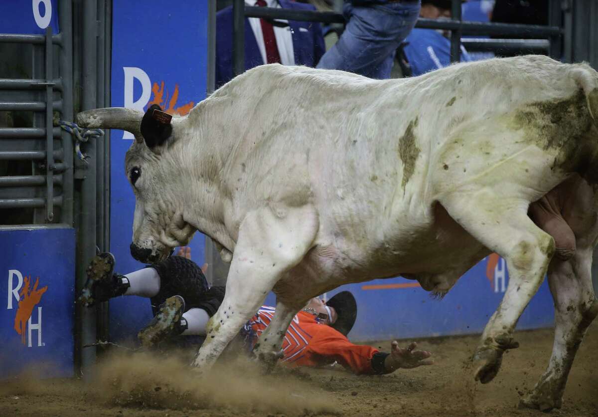 Bullfighter Bryce Redo is taken down by a bull that wouldn’t race in bull riding during Super Series Semifinal 1 at Houston Livestock Show and Rodeo Wednesday, March 16, 2022, at NRG Stadium in Houston.