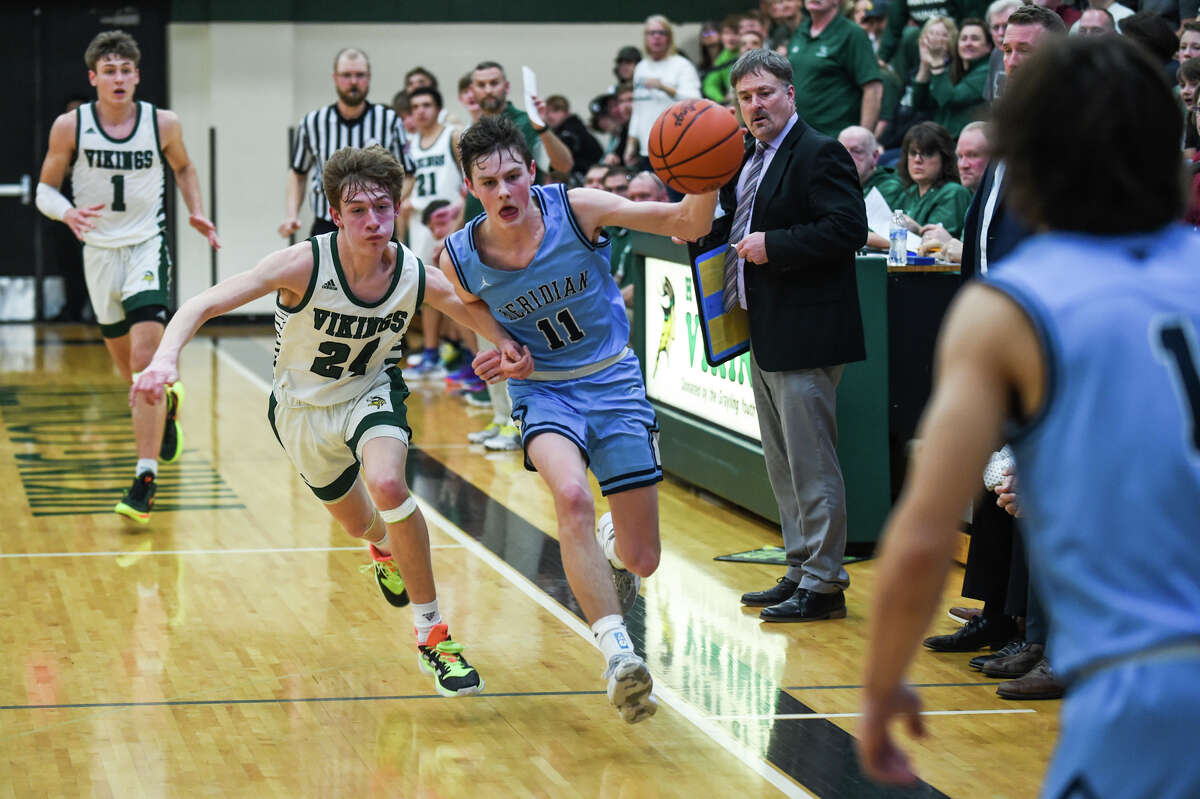 Meridian's Nick Metzger drives down the court during the Mustangs' state regional final loss to Grayling Wednesday, March 16, 2022 at Grayling High School.