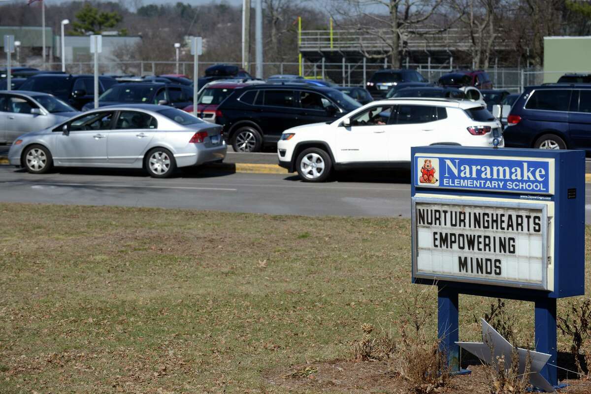 Cars wait in line as school lets out at Naramake Elementary School, in Norwalk, Conn. March 16, 2022.