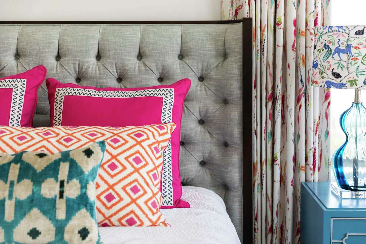 Interior designer Pamela O’Brien mixed colors and patterns in the pillows for the primary bedroom.