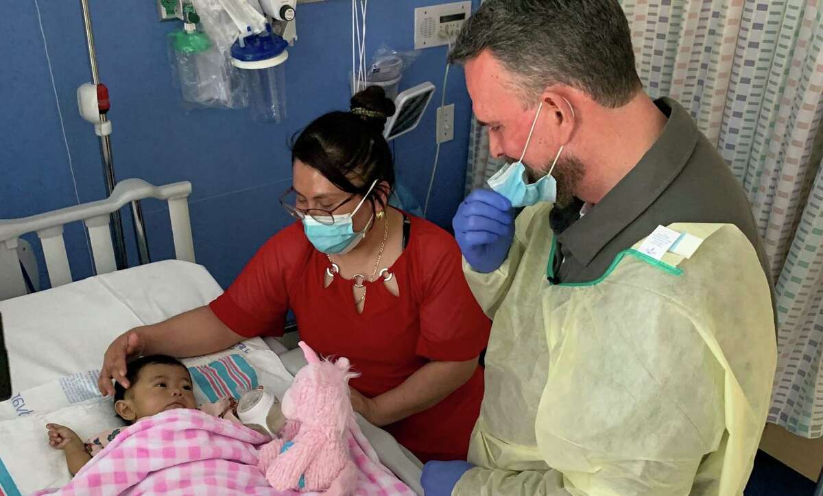 Liver donor John Rubino gave a pink unicorn to 7-month-old recipient Ariany Perez, with her mother looking on. The surgery was performed at the Montefiore Hospital in the Bronx on March 2, 2022.