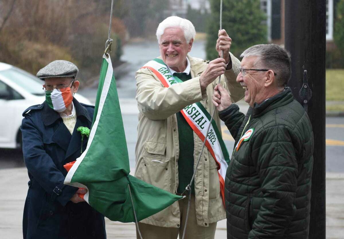 Greenwich Hibernian Association founding member John Halpin, left, former Selectman John Toner, center, and Greenwich Hibernian Association President Hayden O'Shea participate in the St. Patrick's Day flag-raising outside Town Hall in Greenwich, Conn. Thursday, March 17, 2022. Presented by the Greenwich Hibernian Association, the short ceremony celebrated those with Irish ancestry, honored parade grand marshal former Selectman John Toner, and raised an Irish flag above Town Hall.