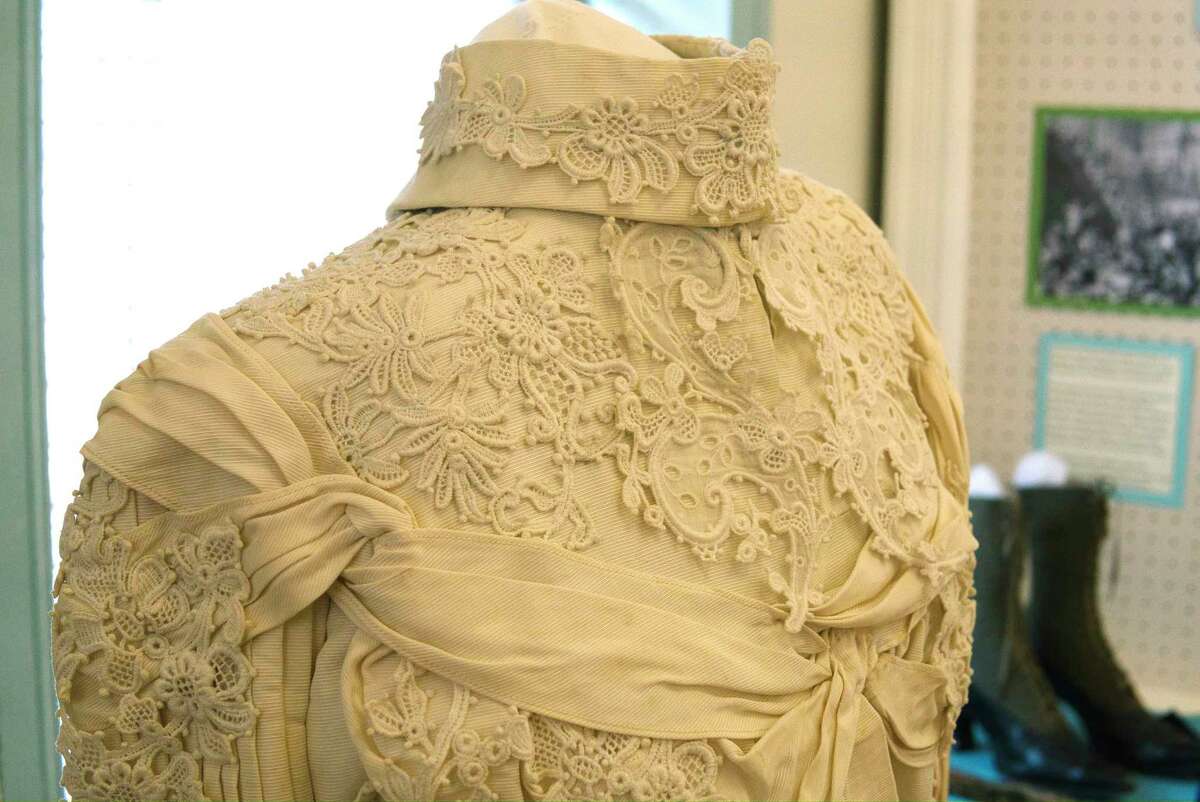 A view of the wedding dress of Anna Hoffman Clapper on display at the Bethlehem Historical Museum on Thursday, March 17, 2022, in Selkirk, N.Y. The museum currently has an exhibit about her life. Clapper made the dress, which white silk trimmed with crocheted Irish lace.