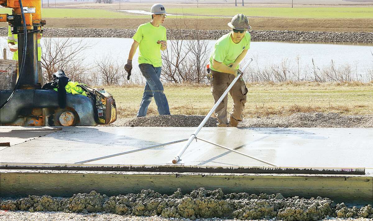 John Badman|The Telegraph Workers were spreading fresh concrete for the first pour on the new elevated lanes of southbound U.S. 67 in West Alton, Missouri, Thursday. The $3.9 million project will elevate southbound traffic for about 3 miles after it crosses the Clark Bridge from Alton into Missouri. 