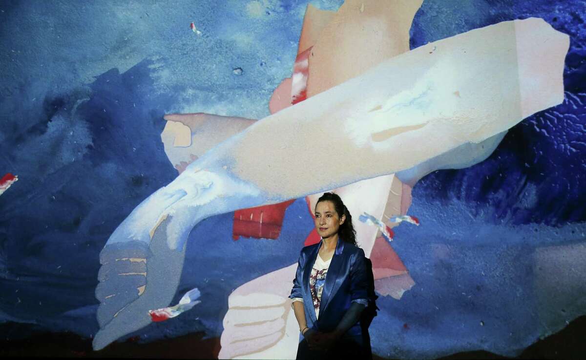 Pakistan-born artist Shahzia Sikander stands in the projection of her artwork titled “Parallax” at the MFAH on Thursday, March 17, 2022 in Houston. Sikander’s “Extraordinary Realities” opens at the MFAH on Sunday, March 20, 2022.