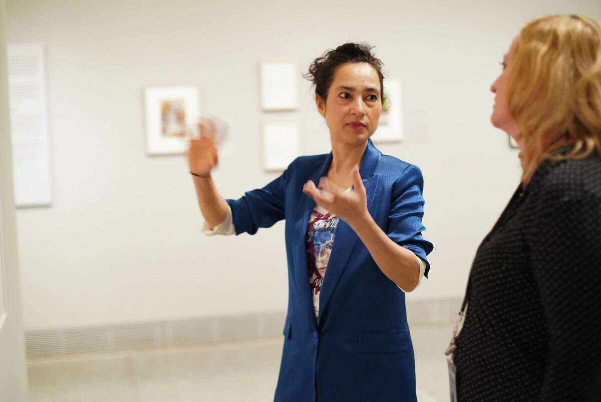 Shahzia Sikander, left, talks about one of her pieces with MFAH curator for prints and drawings, Dena Woodall, in Houston on Thursday, March 17, 2022. Sikander’s “Extraordinary Realities” opens at the MFAH on Sunday, March 20, 2022.