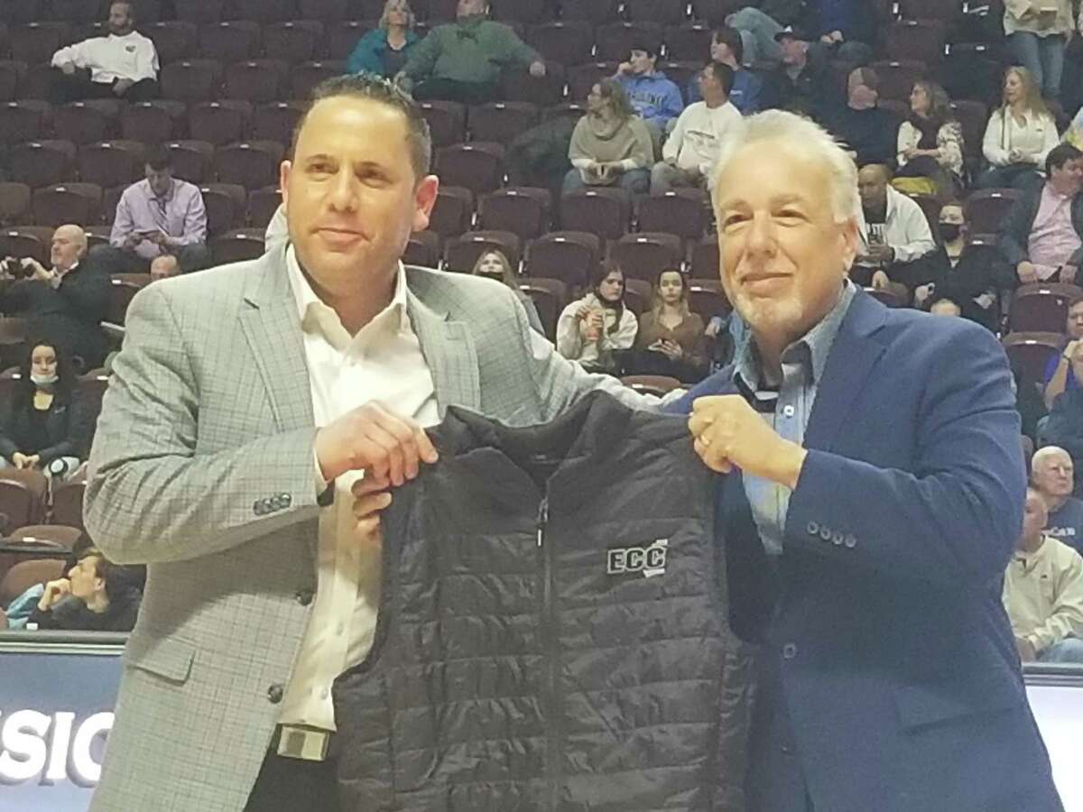 Tom Cantone, the president of sports and entertainment for Mohegan Gaming & Entertainment, is presented with a gift by Ledyard athletic director Jim Buonocore at the ECC championship boys basketball games at the Mohegan Sun Arena in Uncasville March 1.