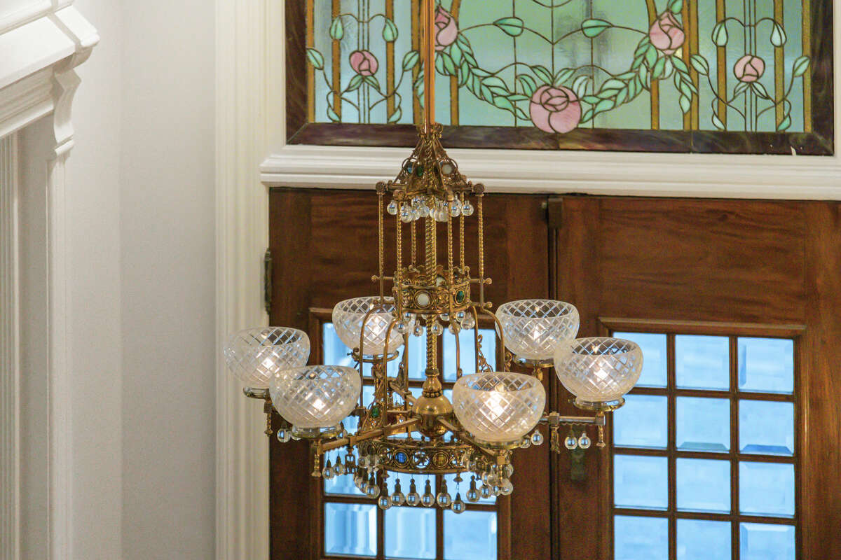 Classic leaded and stained glass in the home's vestibule add sparkle to this vintage light fixture.