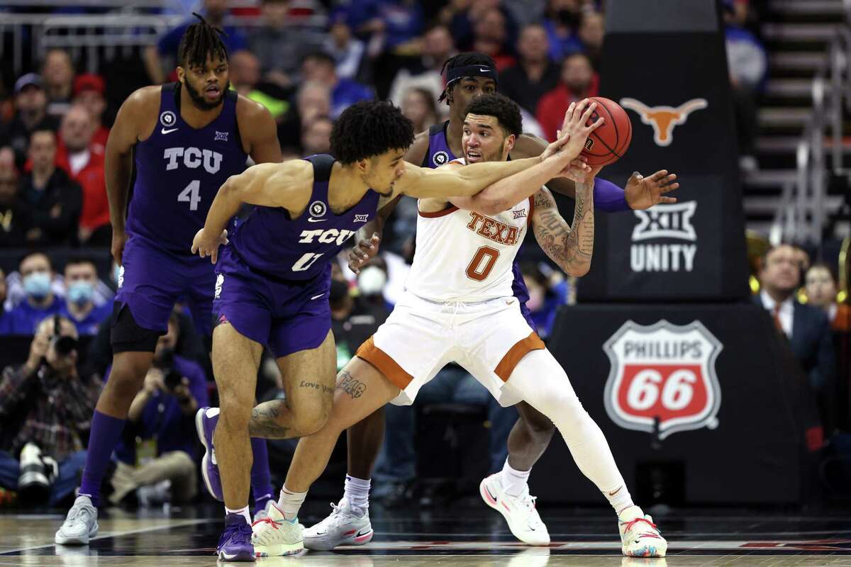 KANSAS CITY, MISSOURI - MARCH 10: Micah Peavy #0 of the TCU Horned Frogs guards Timmy Allen #0 of the Texas Longhorns in the second half during the first round game of the 2022 Phillips 66 Big 12 Men's Basketball Tournament at T-Mobile Center on March 10, 2022 in Kansas City, Missouri. (Photo by Jamie Squire/Getty Images)