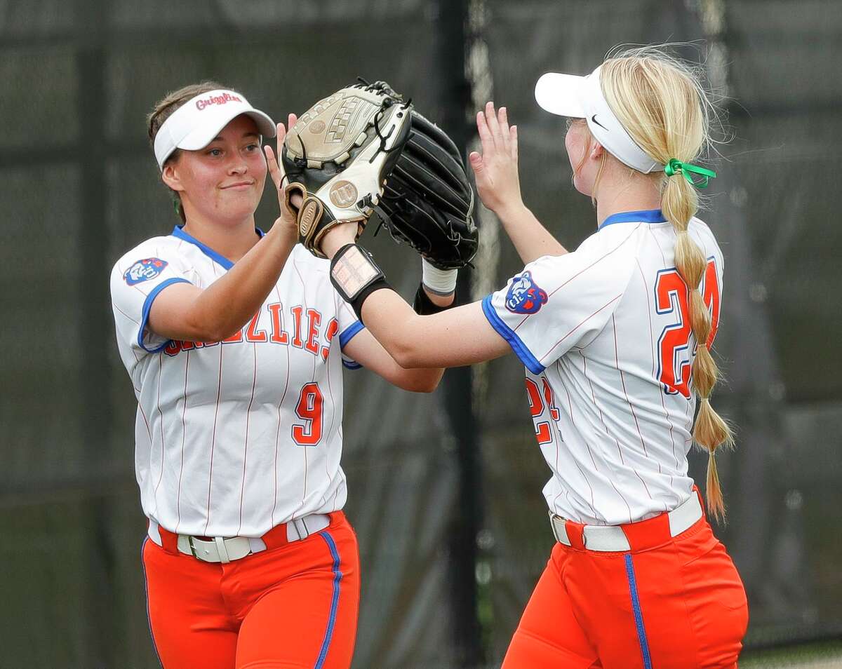 Grand Oaks left fielder Meagan Hopkins (9) gets a high-five from shortstop Kaet Dunbar (24) after catching a fly ball by Angelina Postel #3 of Magnolia to end the top of the third inning of a high school softball game at Grand Oaks High School, Thursday, March 17, 2022, in Spring.