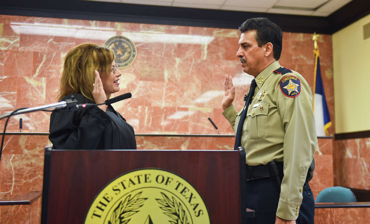 Constable for Precinct 1 Rudy Rodriguez is sworn in by Judge Rosie Cuellar on Monday, Jan. 2, 2017 at the Webb County Justice Center.