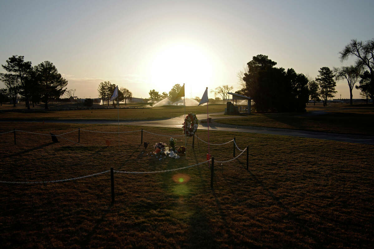 The sun rises behind a makeshift memorial at the Rockwind Community Links Thursday, March 17, 2022, in Hobbs, N.M. The memorial was for student golfers and the coach of University of the Southwest killed in a crash in Texas. (AP Photo/John Locher)