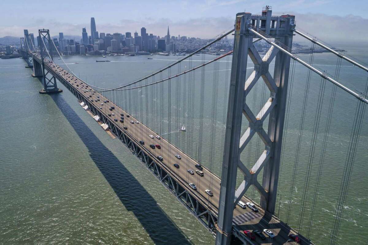 This file photograph shows drivers making their way into San Francisco on the Bay Bridge in as seen from Treasure Island in San Francisco, Calif., on Sunday, July 25, 2021.