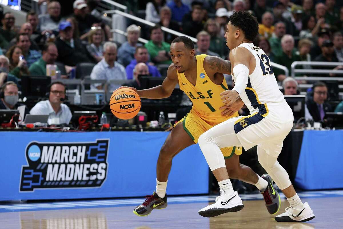 INDIANAPOLIS, INDIANA - MARCH 17: Jamaree Bouyea #1 of the San Francisco Dons drives against Carter Collins #13 of the Murray State Racers during the first half in the first round game of the 2022 NCAA Men's Basketball Tournament at Gainbridge Fieldhouse on March 17, 2022 in Indianapolis, Indiana. (Photo by Dylan Buell/Getty Images)