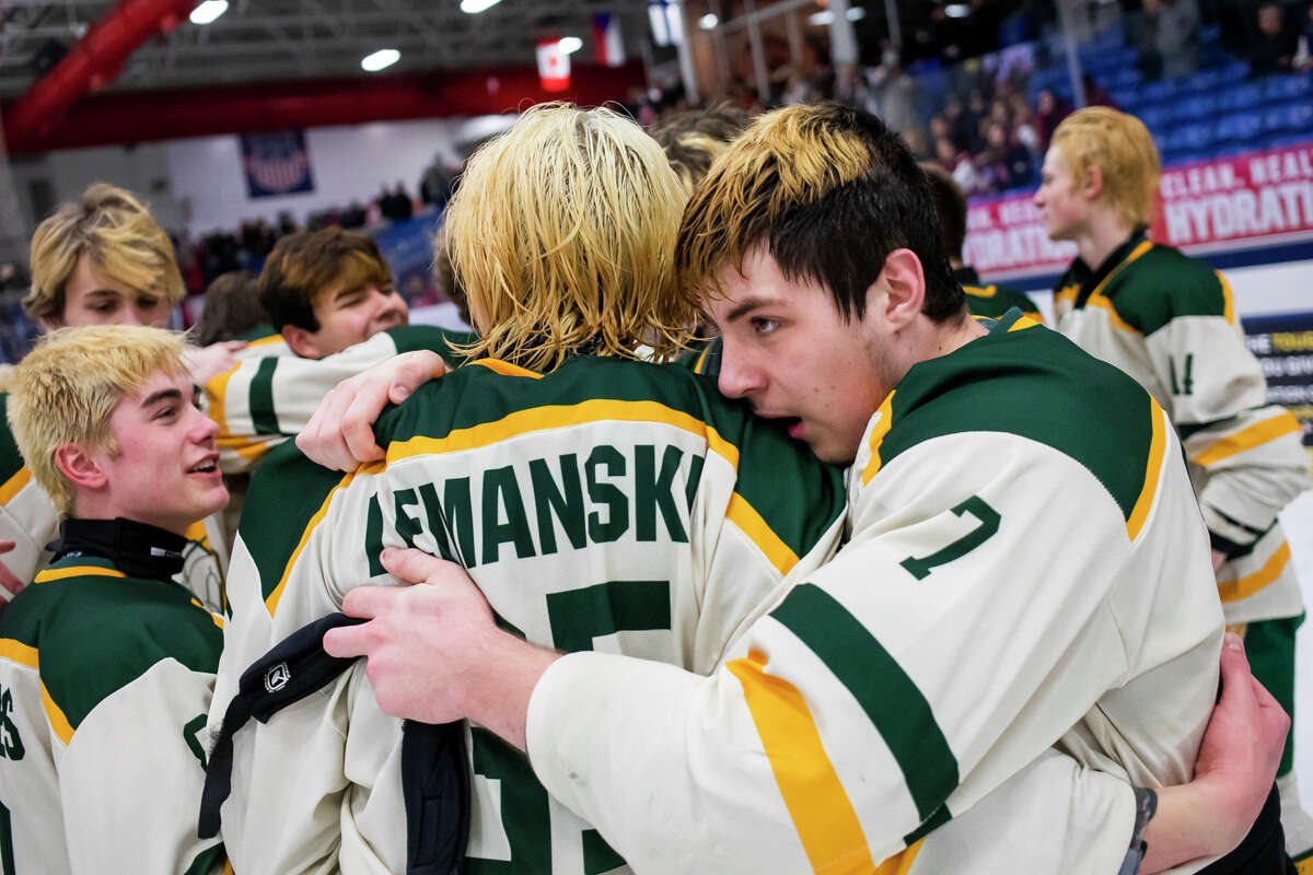 Dow High's Collin Lemanski is hugged by teammate Jack Coppens following a March 12, 2022 state championship game against Orchard Lake St. Mary's.