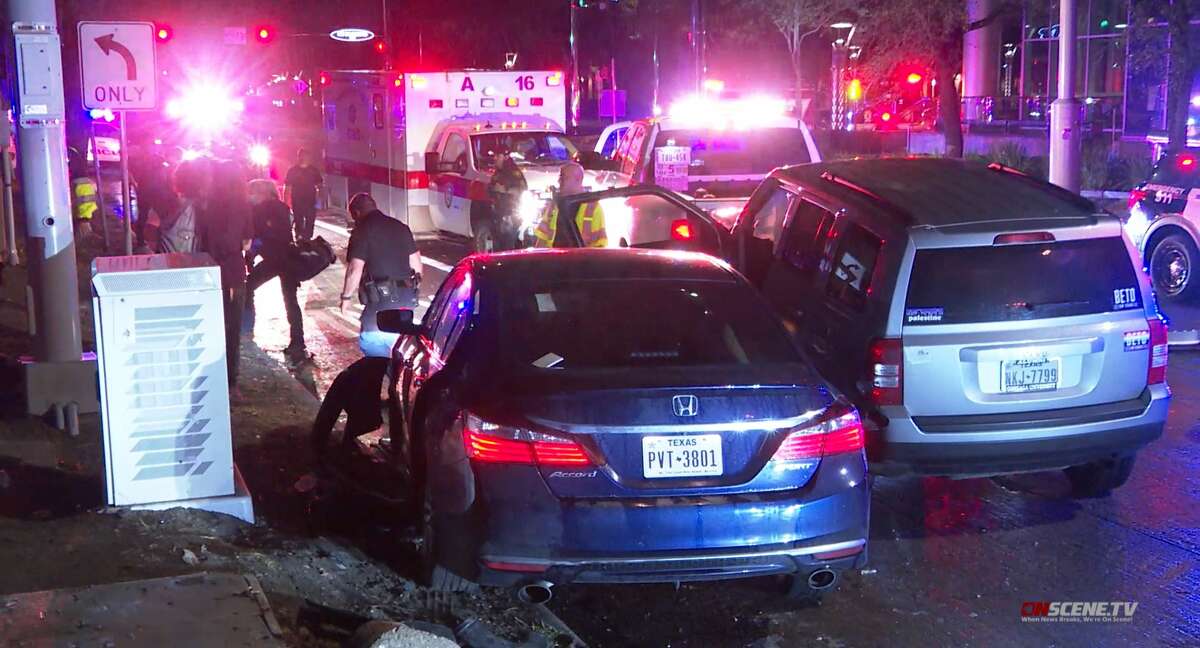 Houston police investigate a crash that hit a DWI scene and injured an officer and driver near the West Loop on Post Oak Road on March 18, 2022