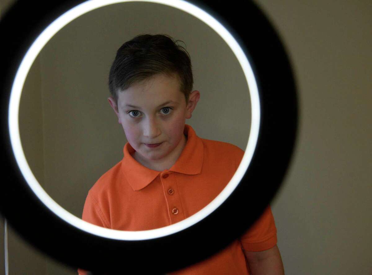 Roger Shaw, of Gaylordsville, uses a light ring to practice delivering part of his audition. Shaw is an 11-year-old child actor who has appeared in TV shows and commercials. Thursday, March 3, 2022, New Milford, Conn.