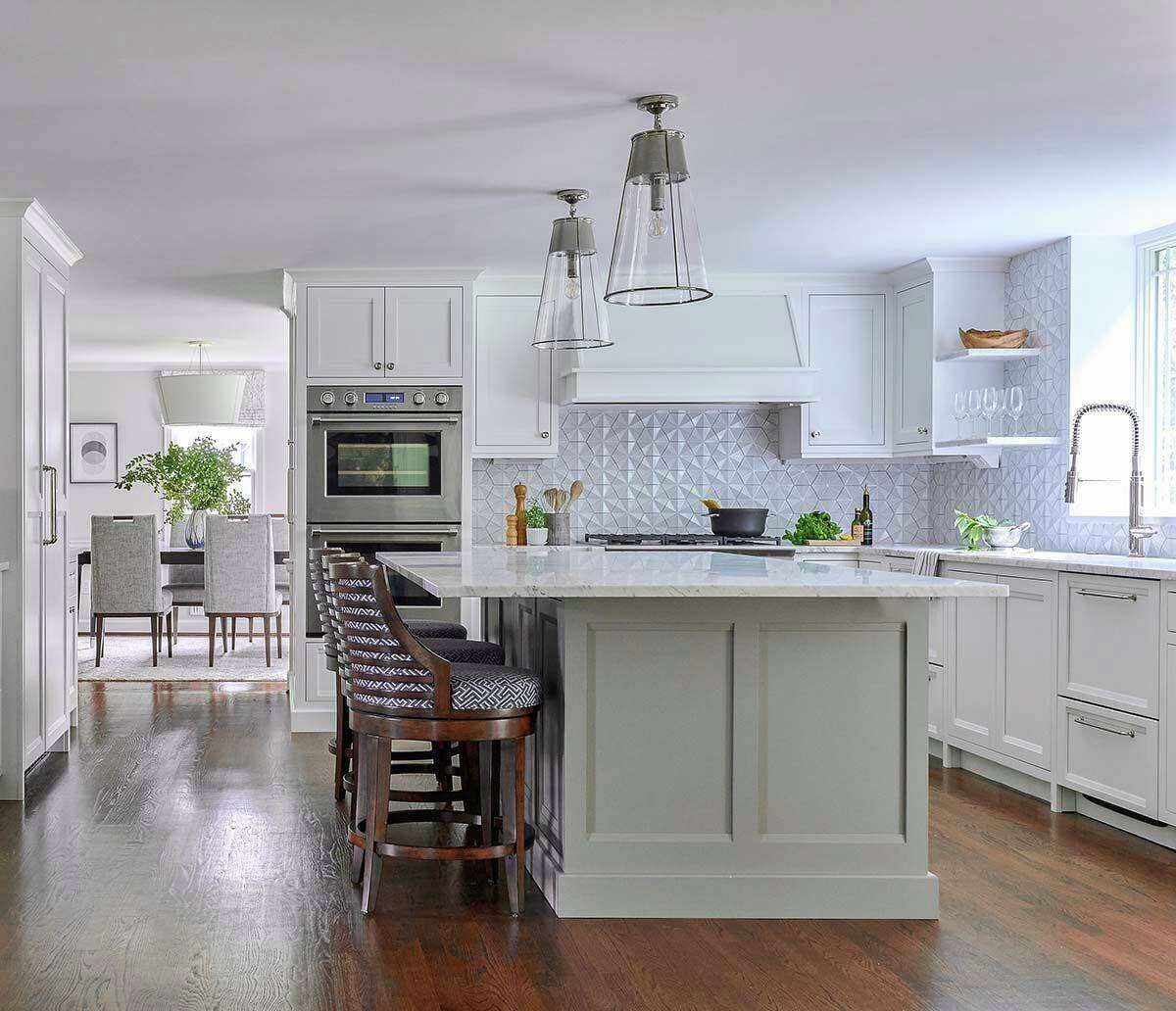 After a floor-to-ceiling support column was removed from the island, the eye can focus on other things, like marble countertops, a Fisher & Paykel cooktop and a geometric, three-dimensional backsplash.