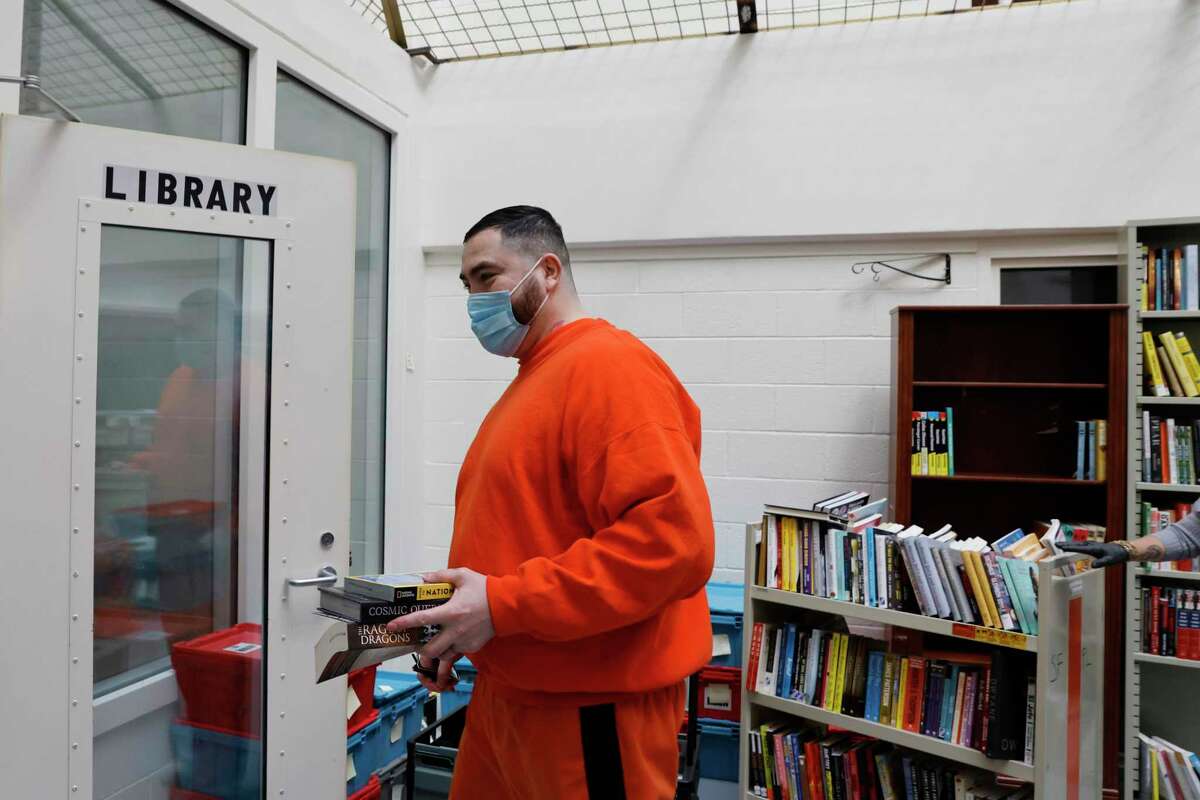 Joshua Soto of Fresno checks out three new books at San Francisco County Jail No 2. While incarcerated people aren’t normally allowed into the library, Soto was there for a Chronicle interview. American jails and prisons are hoping to take a page from the S.F. jail’s well-funded and well-stocked library program.