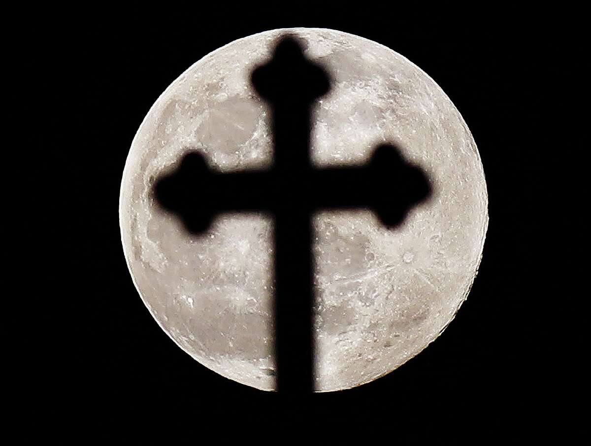 John Badman|The Telegraph The full Worm Moon, or Lenten Moon, rises above the cross atop St. Mary's Catholic Church in Alton late Wednesday night. Commonly known as Worm Moon, the current full moon is the last of the winter season, a time when thawing ground allows worms and other insects to become active again. According to The Old Farmer's Almanac, since this full moon occurred before the spring equinox it is also called the Lenten Moon, referring to the Christian season. Different Native American cultures have different names for the last full moon of winter, including Eagle Moon, Goose Moon, Crow Moon, Sugar Moon and Sore Eyes Moon. Whatever you wish to call it, you can see the full moon rising in the eastern sky just before 7 p.m. Winter is officially over, and spring starts, in North America on Sunday.