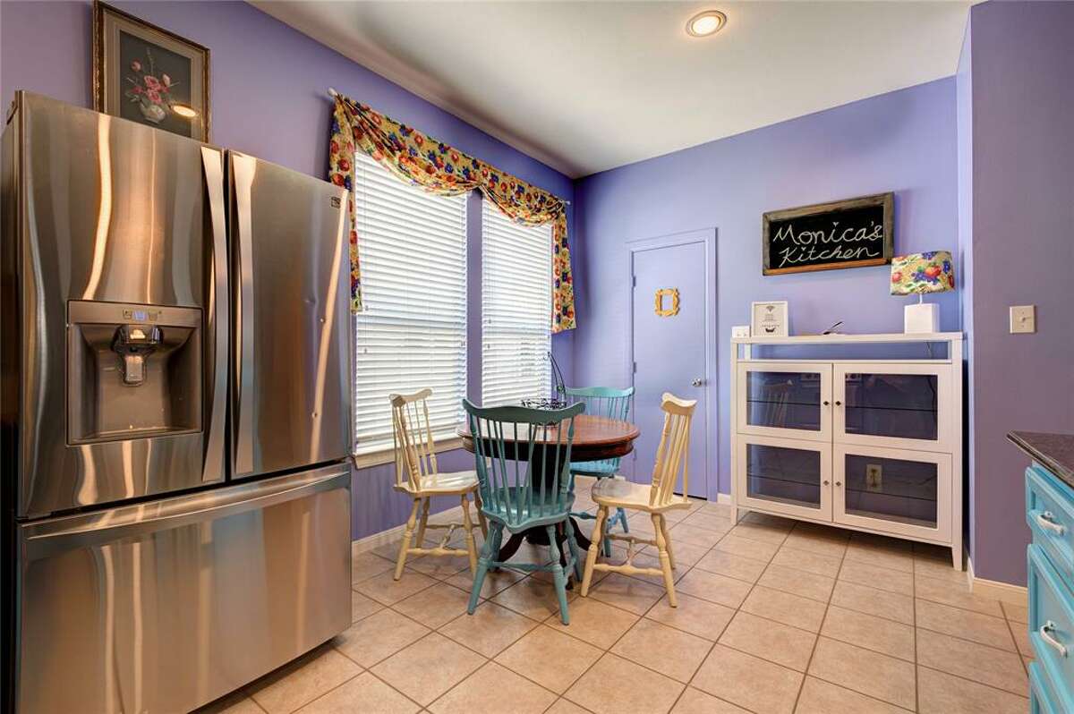 A chalkboard hanging in the kitchen reads "Monica's kitchen." 