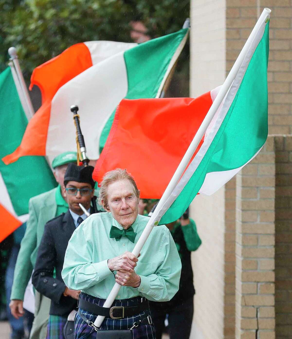 Michael McDougal carries an Irish flag as he leads the annual St. Patrick’s Day walking parade through downtown Conroe, Thursday, March 17, 2022, in Conroe.