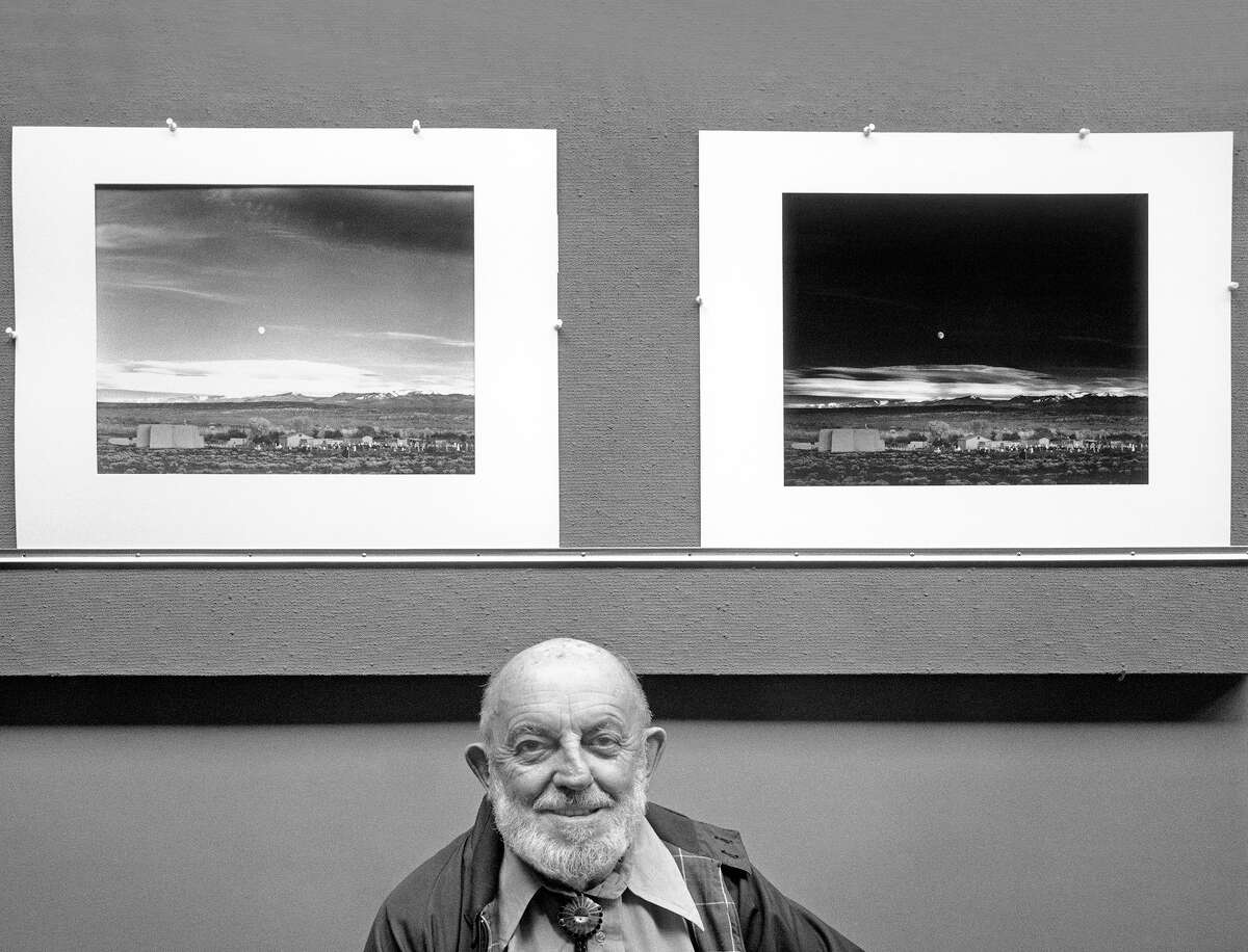 Ansel Adams poses with two prints of his iconic "Moonrise, Hernandez" photograph at his Carmel Highlands home in 1981. 