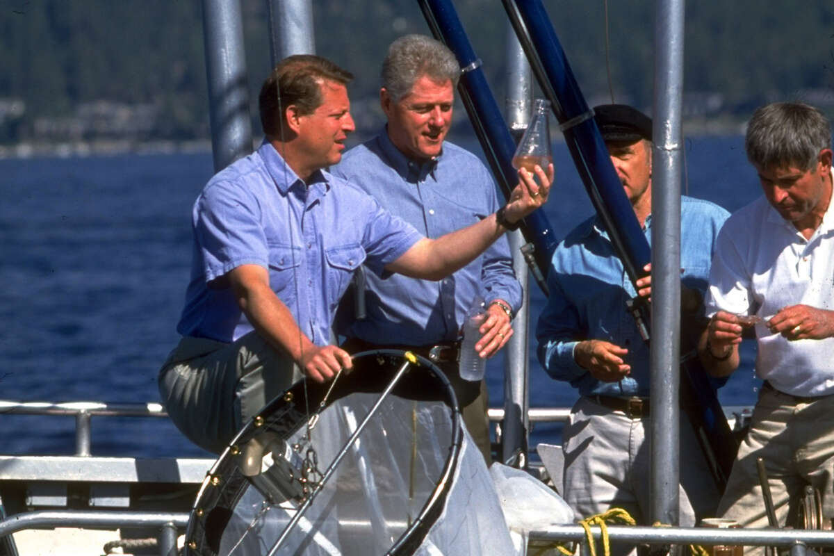 A file photo of former Vice President Al Gore, left, and President Bill Clinton examining a water sample while on an environmental outing on Lake Tahoe.