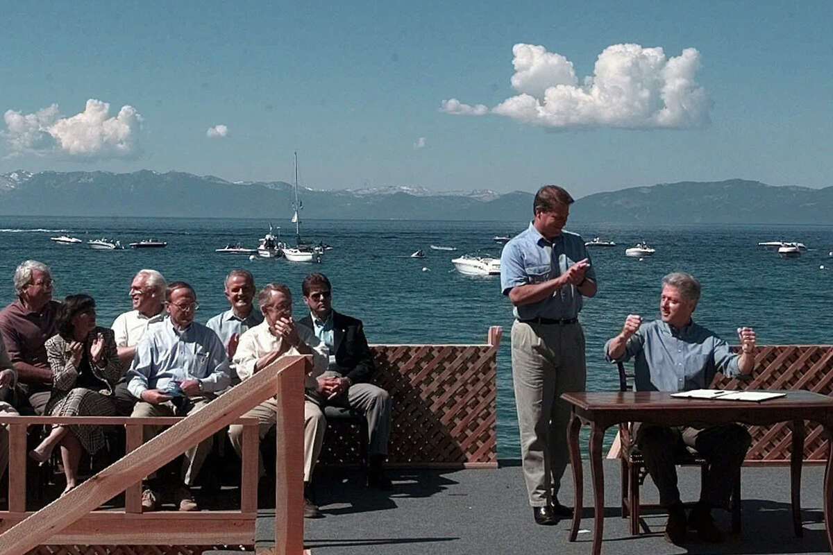 In this July 26, 1997, file photo, former President Bill Clinton and Vice President Al Gore react after signing an executive order on the preservation of Lake Tahoe in Incline Village, Nev. 