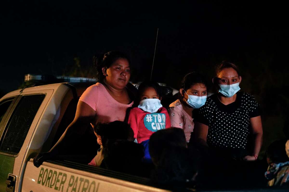 Migrants from Honduras wait in a Border Patrol truck after turning themselves in upon crossing the U.S.-Mexico border Monday, May 17, 2021, in La Joya, Texas. At the time, the Biden administration faced a lawsuit over pandemic-related powers that deny migrants a right to apply for asylum. (AP Photo/Gregory Bull)