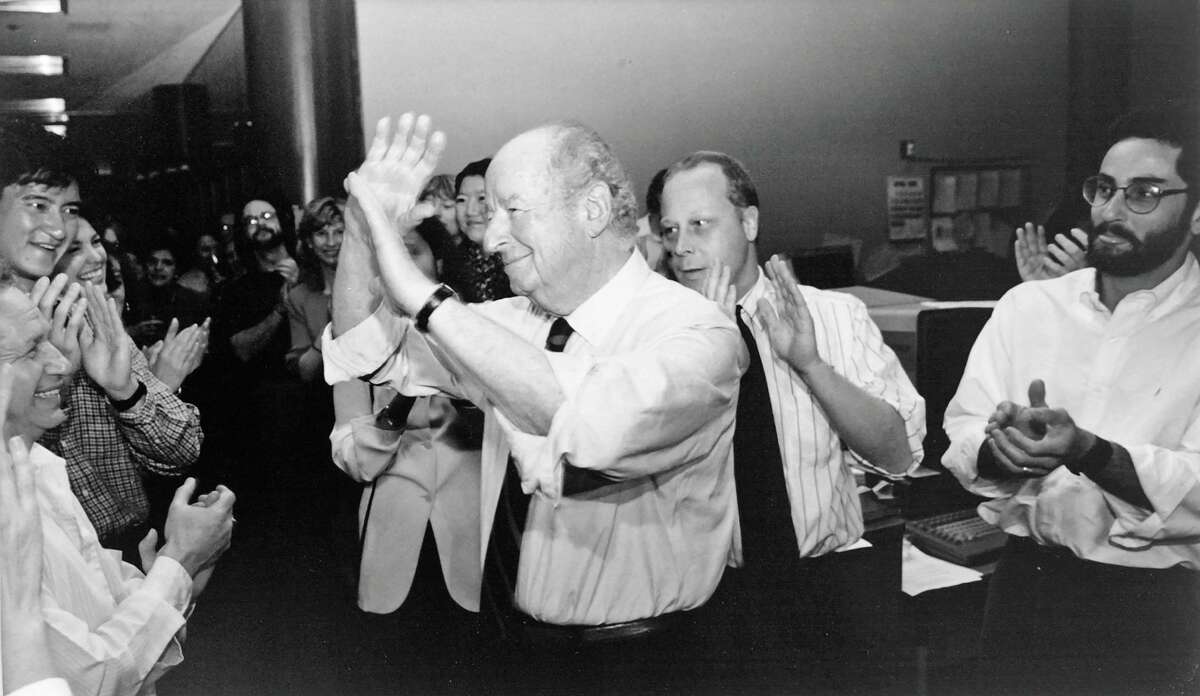Mark Lundgren (center right) applauds with colleagues after Chronicle columnist Herb Caen won the Pulitzer Prize in 1996.