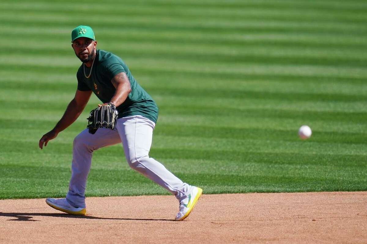 Oakland Athletics shortstop Elvis Andrus moves over to field a grounder during a baseball spring training workout Wednesday, March 16, 2022, in Mesa, Ariz. (AP Photo/Ross D. Franklin)