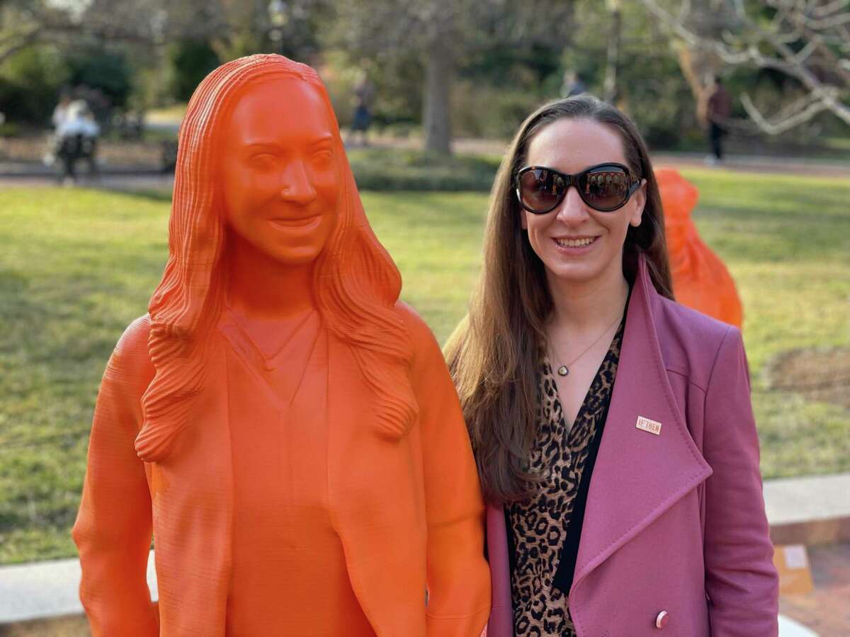 Erika Kurt poses with a life-sized statue of herself at the Smithsonian Institution in Washington, D.C.