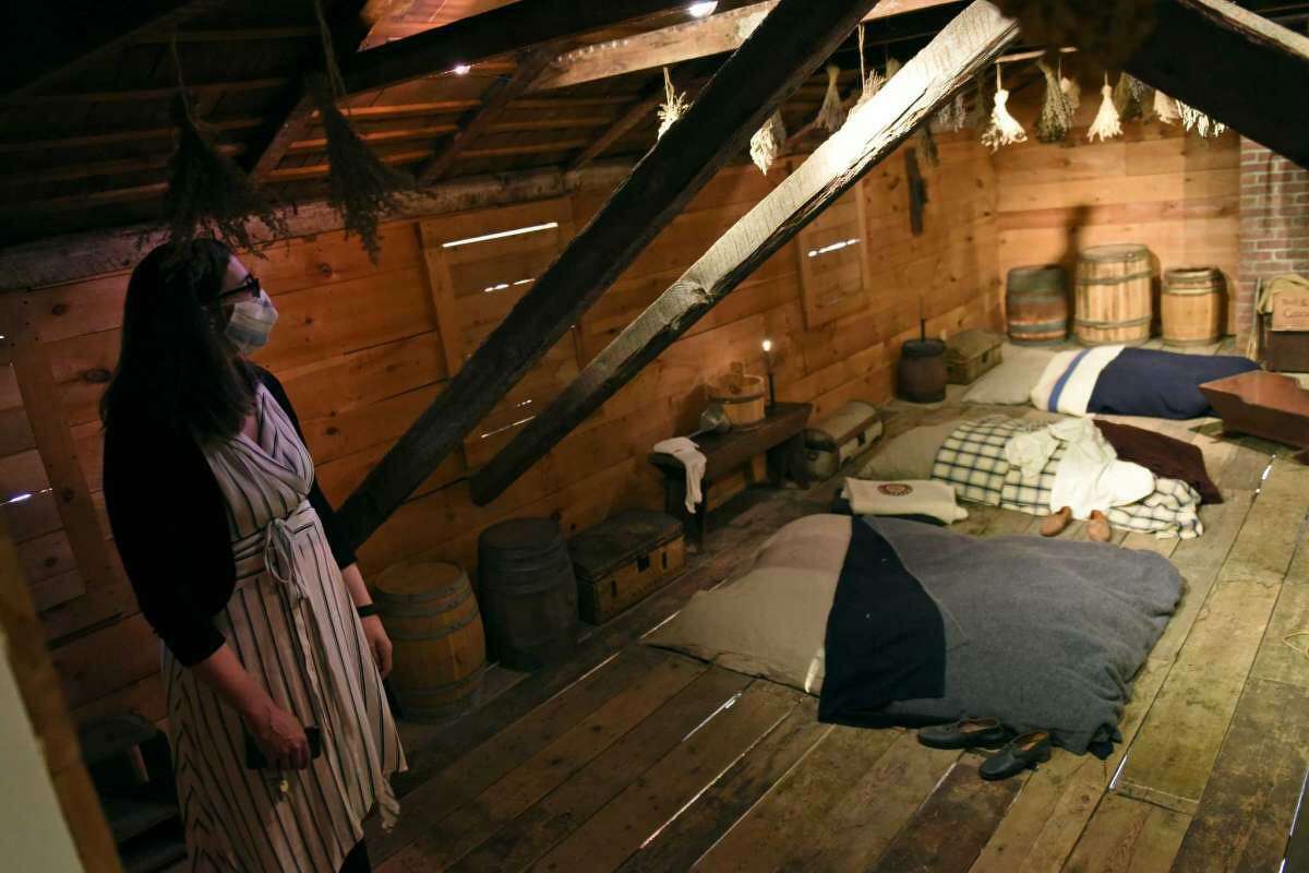 Anna Greco, who the director of education at the time, shows the upstairs slave quarters at the Bush-Holley House at the Greenwich Historical Society in the Cos Cob section of Greenwich in March 2021.