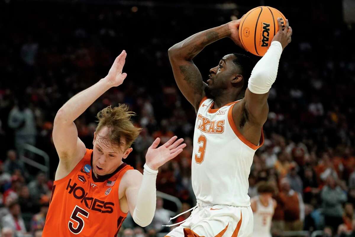 Texas's Courtney Ramey drives past Virginia Tech's Storm Murphy during the first half of a first round NCAA college basketball tournament game Friday, March 18, 2022, in Milwaukee.