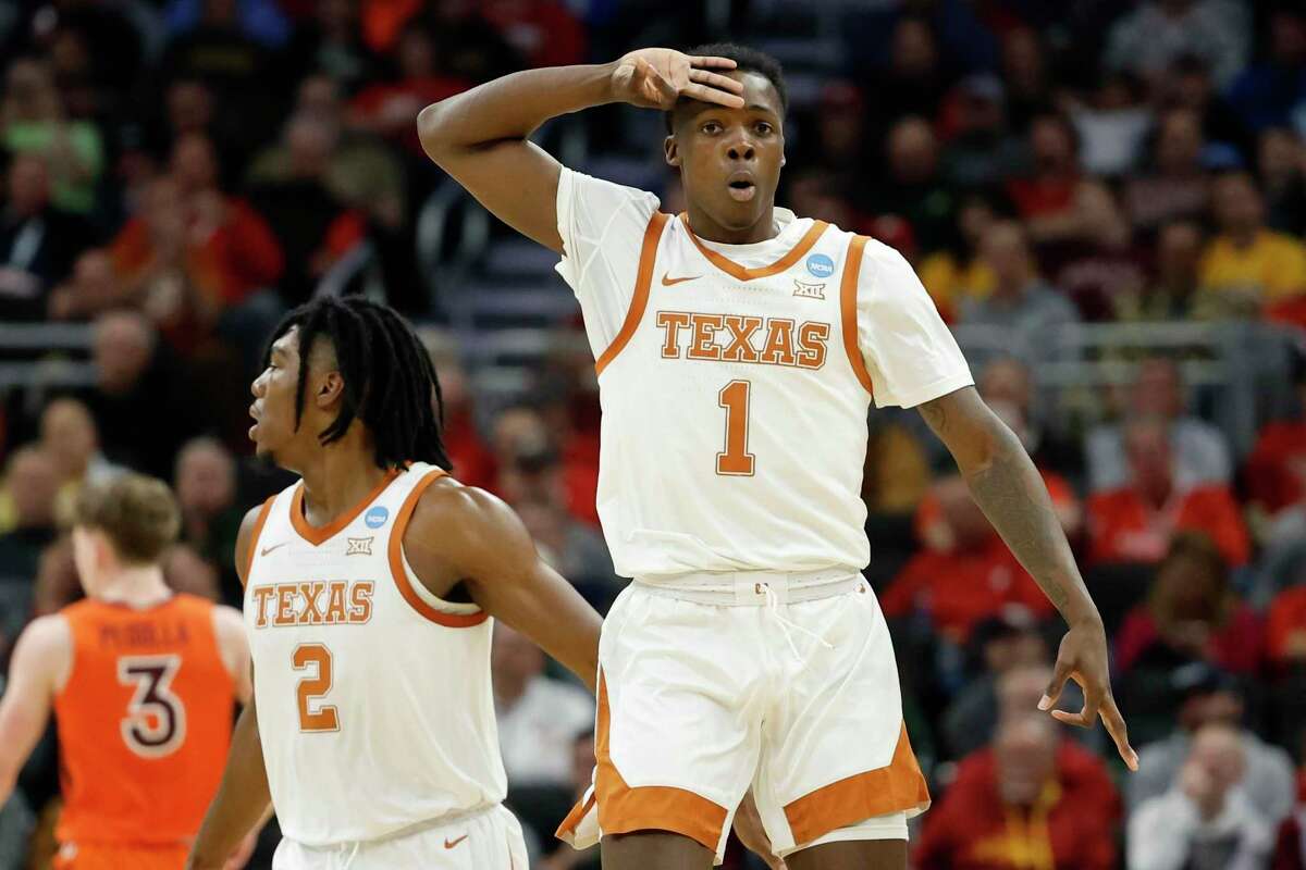 Texas's Andrew Jones reacts after maiking a three-point basket during the first half of a first round NCAA college basketball tournament game against Virginia Tech Friday, March 18, 2022, in Milwaukee. (AP Photo/Jeffrey Phelps)