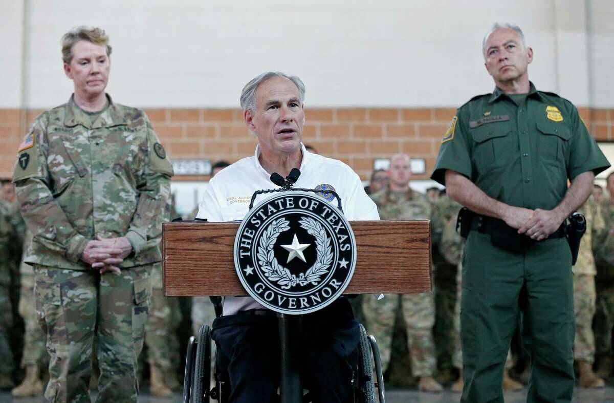 Texas Gov. Greg Abbott (center) speaks at an Army National Guard armory in Weslaco in 2018 as then-Brig. Gen. Tracy R. Norris (left) and RGV Border Patrol Sector Chief Manuel Padilla Jr. look on.