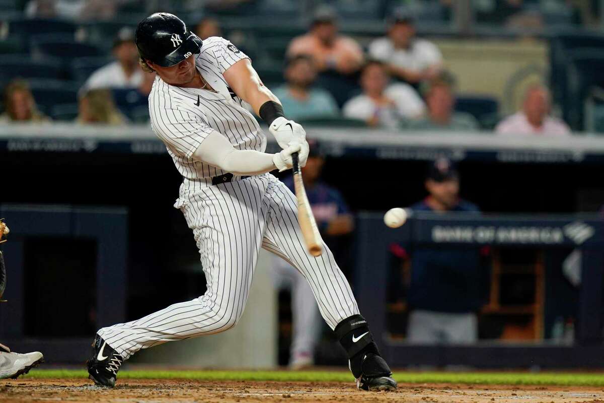 New York Yankees' Luke Voit hits a two-run double during the third inning of the team's baseball game against the Minnesota Twins on Thursday, Aug. 19, 2021, in New York. (AP Photo/Frank Franklin II)