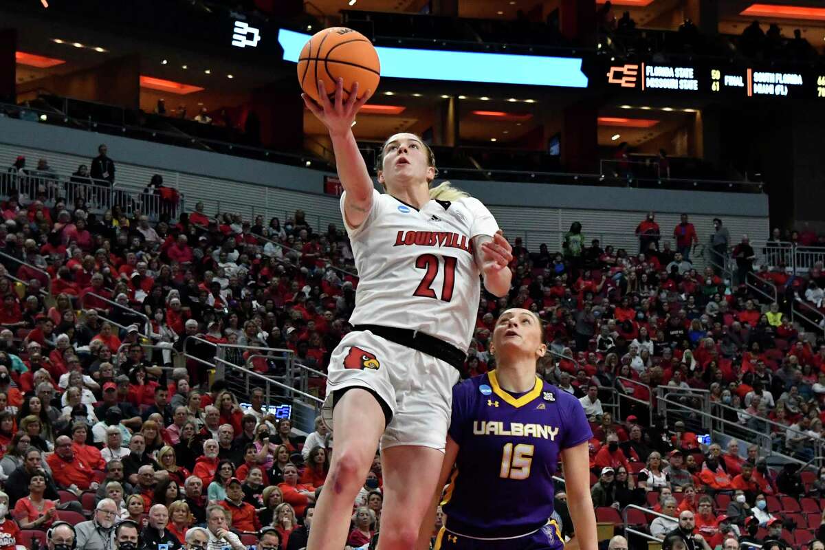 Louisville forward Emily Engstler (21) goes in for a layup past Albany guard Morgan Haney (15) during the second half of their women's NCAA Tournament college basketball first round game in Louisville, Ky., Friday, March 18, 2022. Louisville won 83-51. (AP Photo/Timothy D. Easley)