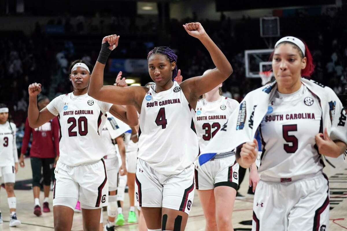 South Carolina forwards Aliyah Boston (4), Victaria Saxton (5) and Sania Feagin (20) celebrate after a first-round game against Howard in the NCAA women's college basketball tournament Friday, March 18, 2022 in Columbia, S.C. South Carolina won 79-21. (AP Photo/Sean Rayford)