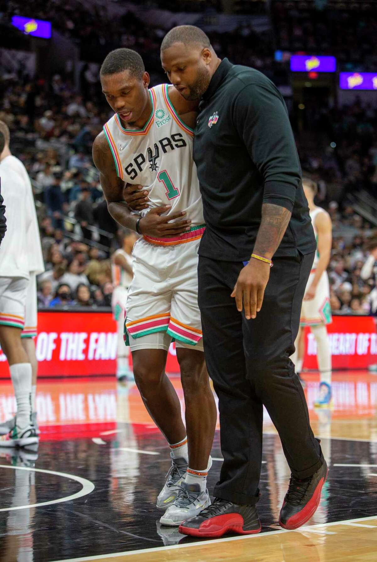 The Spurs?• Lonnie Walker IV is helped off the court Friday night, March 18, 2022 as he leaves the game after being injured in the first half of the Spurs game against the New Orleans Pelicans.