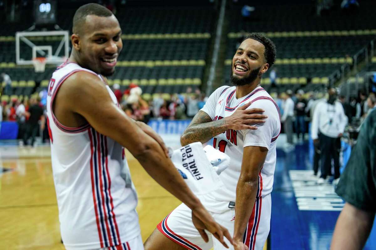 Houston forward Fabian White Jr. (35) and Houston guard Kyler Edwards (11) celebrate at the end of their first-round win over UAB in the NCAA men's college basketball tournament Friday, March 18, 2022, in Pittsburgh.