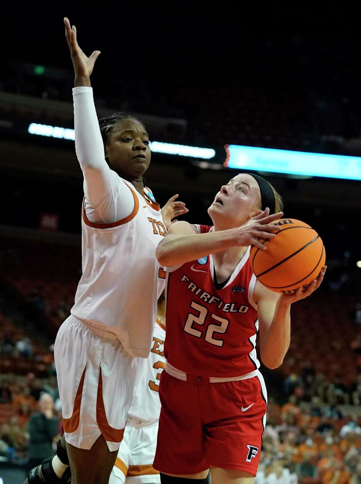 Fairfield guard Rachel Hakes (22) drives to the basket against Texas forward DeYona Gaston, left, during the first half of a college basketball game in the first round of the NCAA women's tournament Friday, March 18, 2022, in Austin, Texas. (AP Photo/Eric Gay)