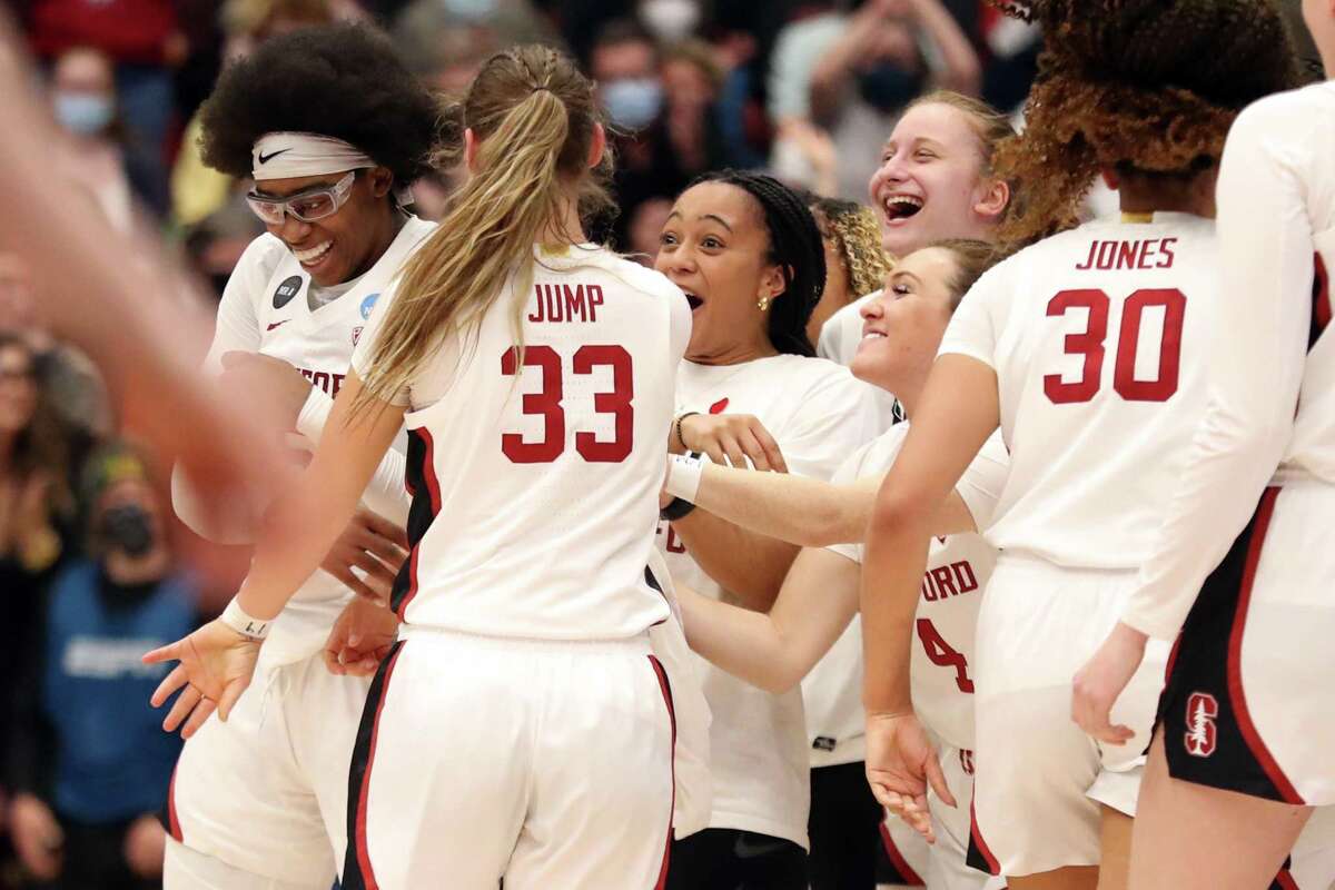 Stanford's Fran Belibi is congratulated by her teammates after dunking in 2nd quarter of 78-37 win over Montana State during NCAA Division I Women's Basketball Championship First Round game at Maples Pavilion in Stanford, Calif., on Friday, March 18, 2022.