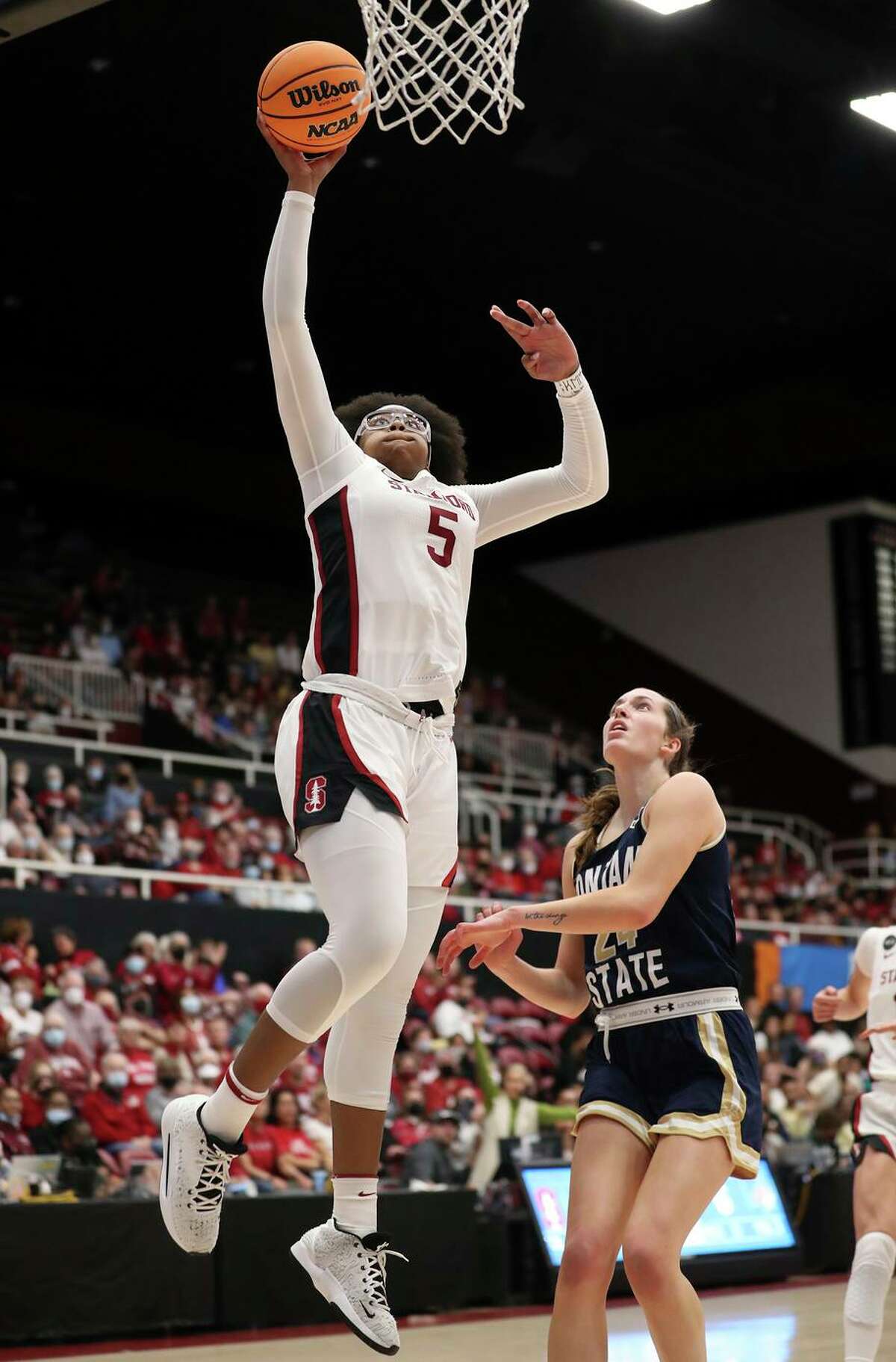 Stanford's Fran Belibi dunks against Montana State's Taylor Janssen in 2nd quarter during NCAA Division I Women's Basketball Championship First Round game at Maples Pavilion in Stanford, Calif., on Friday, March 18, 2022.