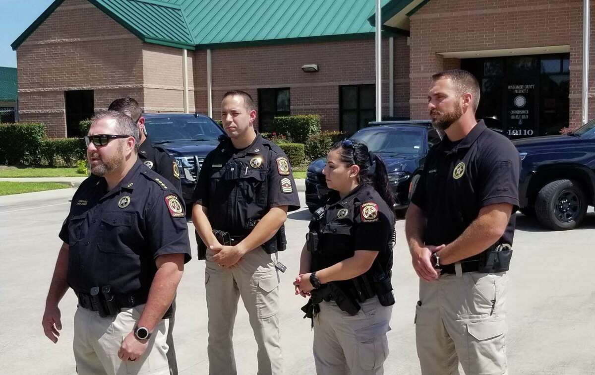 Montgomery County Precinct 5 Constable Chris Jones, on the far left, is seen fielding questions during a press briefing July 2, 2021 as his officers stand behind him in front of the agency's station building in Magnolia. The precinct posts photos of roadside arrests on its Facebook page, which Jones said helps show the public officers’ work patrolling the community.