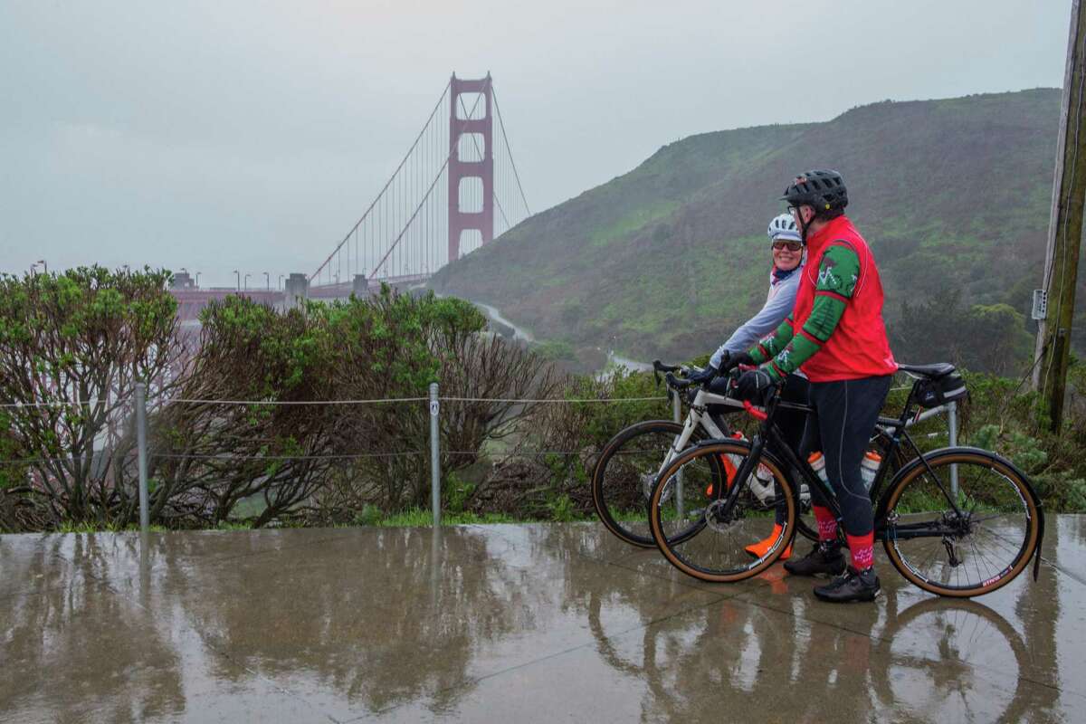 Andi Archer and John Norton, San Anselmo locals, look out over the Golden Gate Bridge during a cold morning bike ride on Highway 101 near Sausalito, Calif. Two lanes acrossa portion of Highway 101 will be closed near Sausalito for scheduled road work. The work was expected to take about 57 hours.